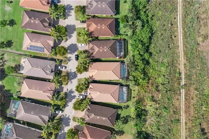 Bird’s-eye perspective highlighting the full property, screened lanai, and pool area.