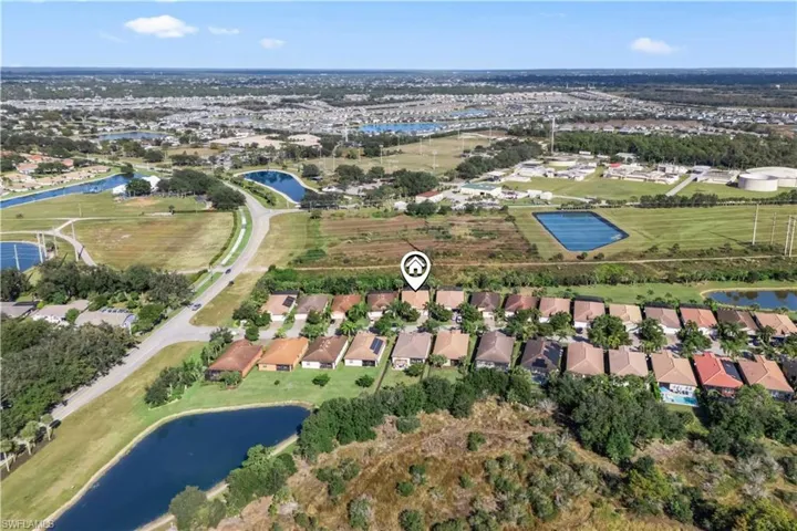 Drone perspective highlighting the community layout, nearby walking and biking trails, and serene surroundings.