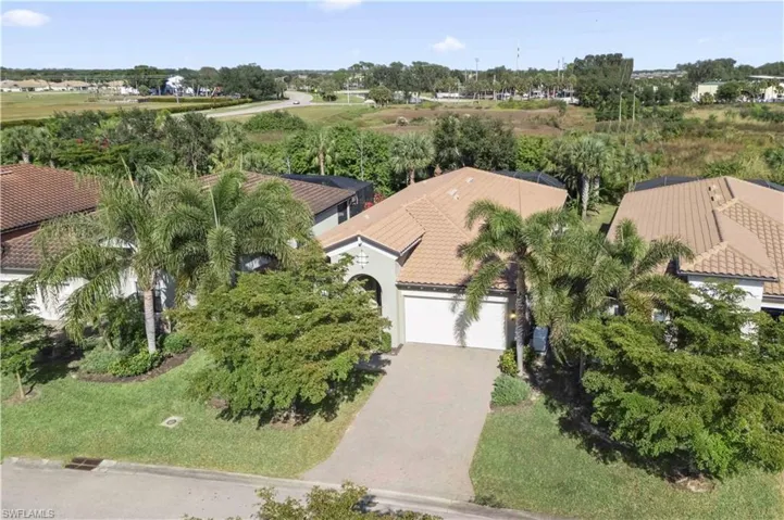 Exterior view capturing the home’s welcoming entry, spacious garage, and tranquil neighborhood setting.