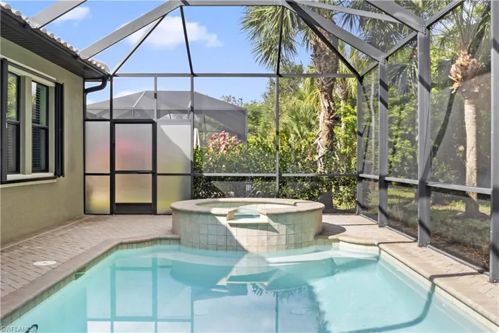 Tropical landscaping enhances the pool and spa area, creating a relaxing, private retreat.