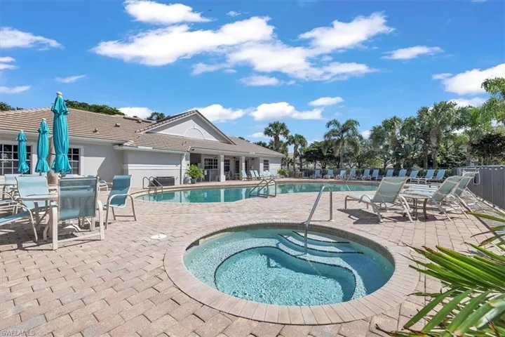 Community pool with a patio, a community hot tub, and outdoor dining area