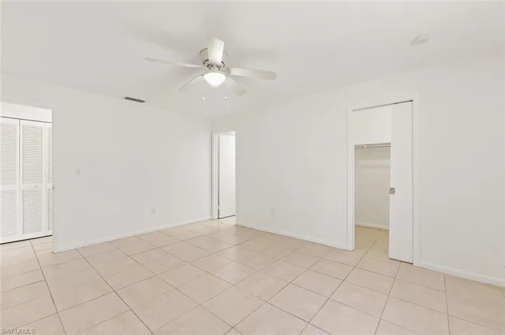 Living room area with tile flooring in unit #3.
