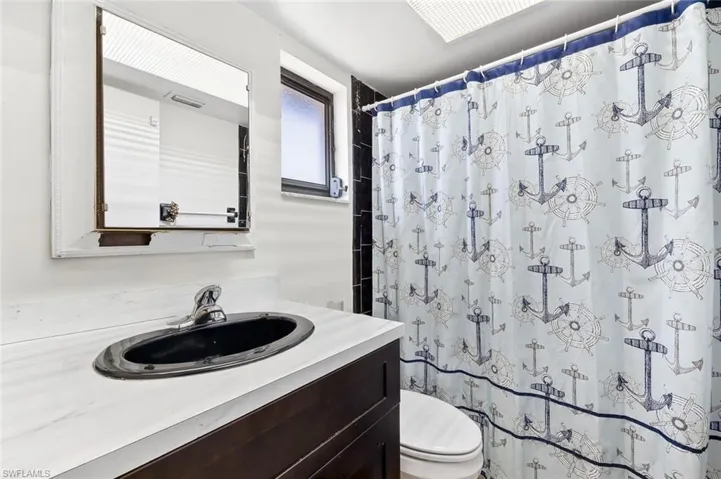 Bathroom two with tile flooring, tiled walk-in shower in unit #3.