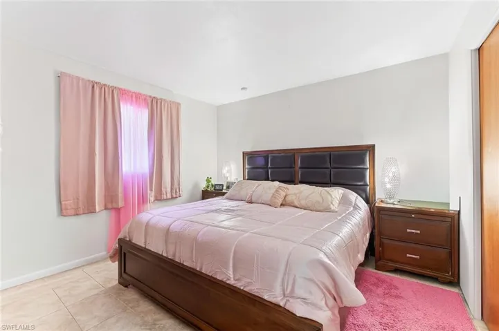 Bedroom one with tile flooring in unit #1.