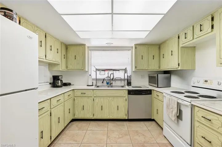 Fully applianced kitchen with tile flooring and in ceiling lighting in unit #2.