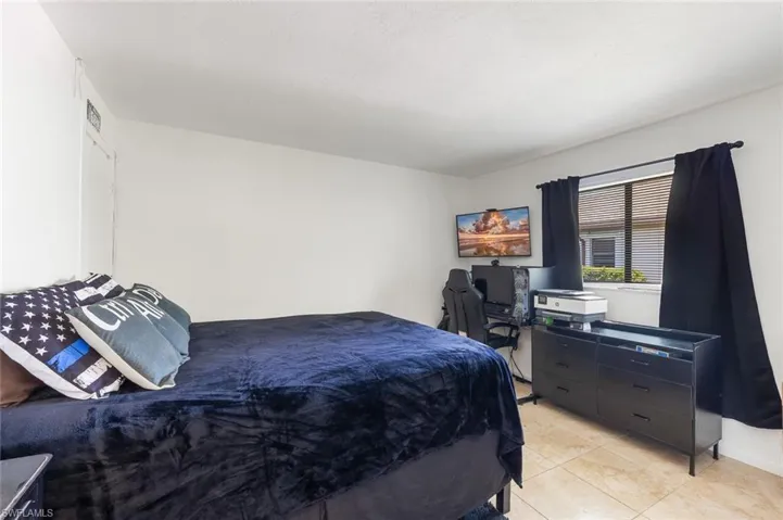 Bedroom one with tile flooring in unit #2.
