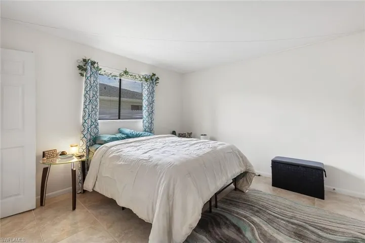 Bedroom two with tile flooring in unit #4.