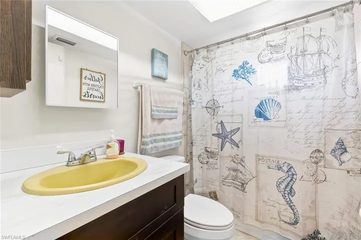 Bathroom one with shower/tub combo and tiled flooring in unit #4.