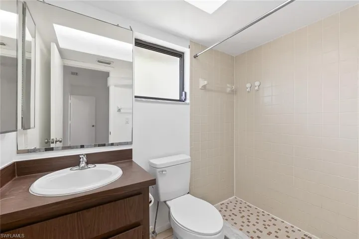 Bathroom one with tile flooring, tiled walk-in shower in unit #3.