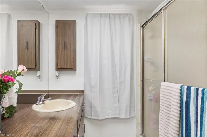 Bathroom two with walk-in shower and tiled flooring in unit #4.