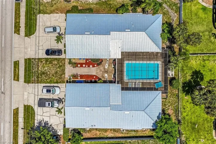 Direct aerial view of the property and lot.