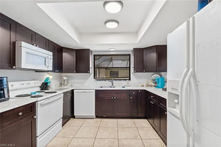 Fully applianced kitchen with tile flooring and in ceiling lighting in unit #4