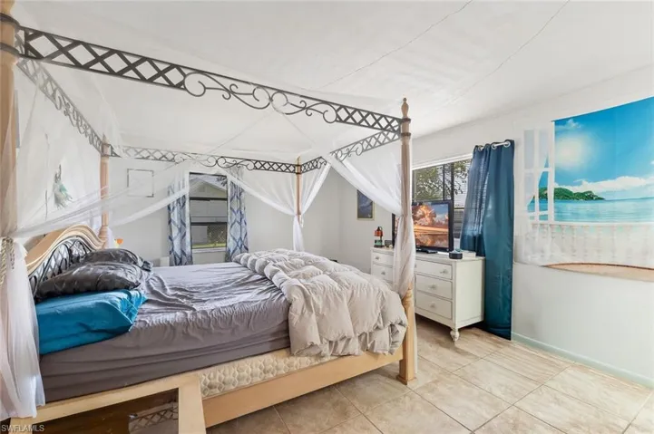 Bedroom one with tile flooring, walk-in closet, ensuite bath, in unit #3.
