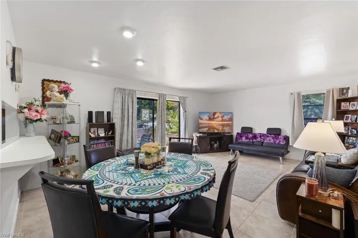 Living/Dining area with tile floors and slider to outside patio in unit #1.