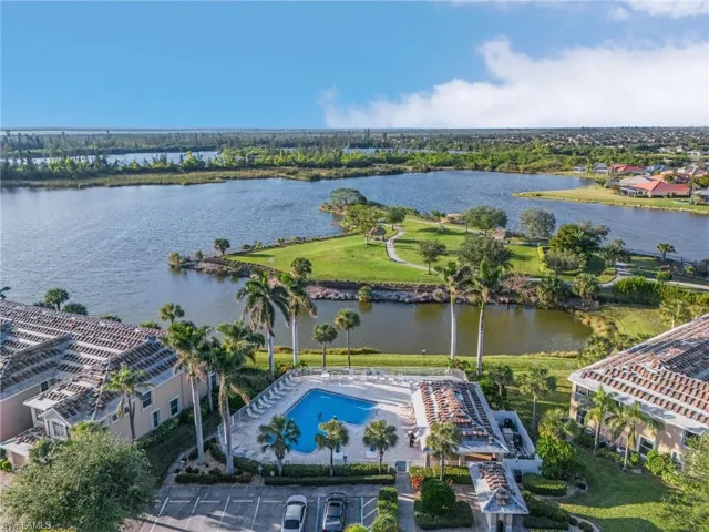 Birds eye view of property with a water view