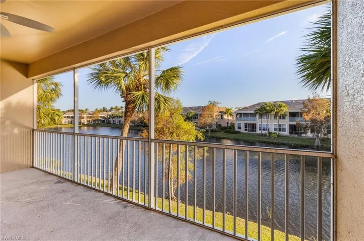 Balcony featuring ceiling fan and a water view
