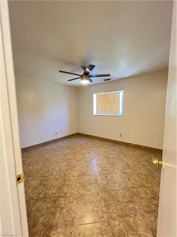 Bedroom featuring ceiling fan and baseboards