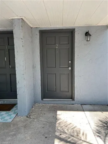 View of exterior entry with stucco siding