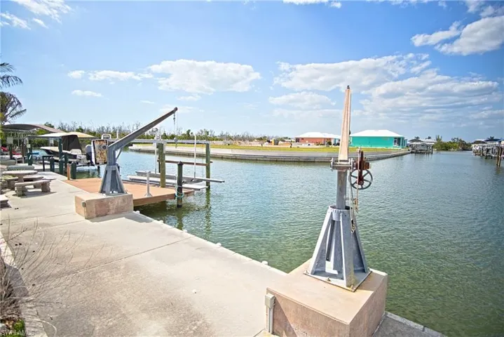 Dock area with boat lift and a water view
