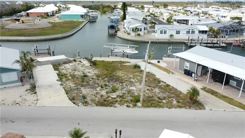 Aerial perspective of suburban area featuring a nearby body of water