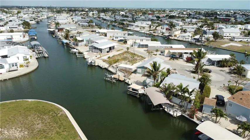 Aerial view of residential area featuring a large body of water