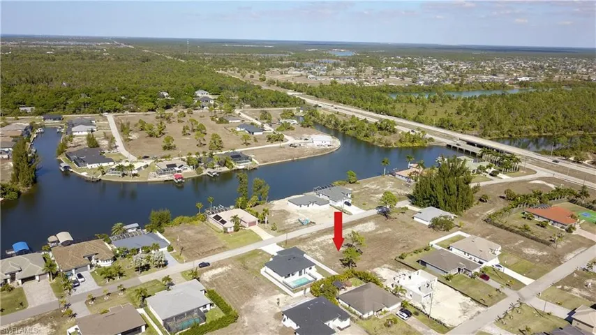 Aerial overview of property's location featuring nearby suburban area and a nearby body of water