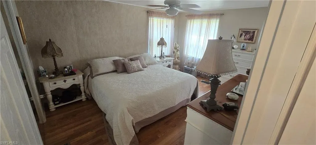 Bedroom with wood finished floors and ceiling fan