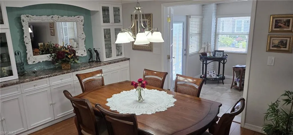 Dining room featuring a chandelier and baseboards