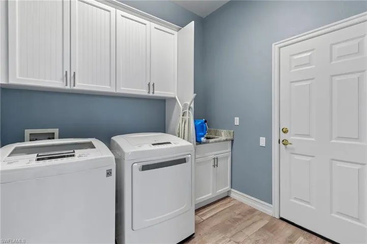 Washer and dryer just off the kitchen and door to the garage.