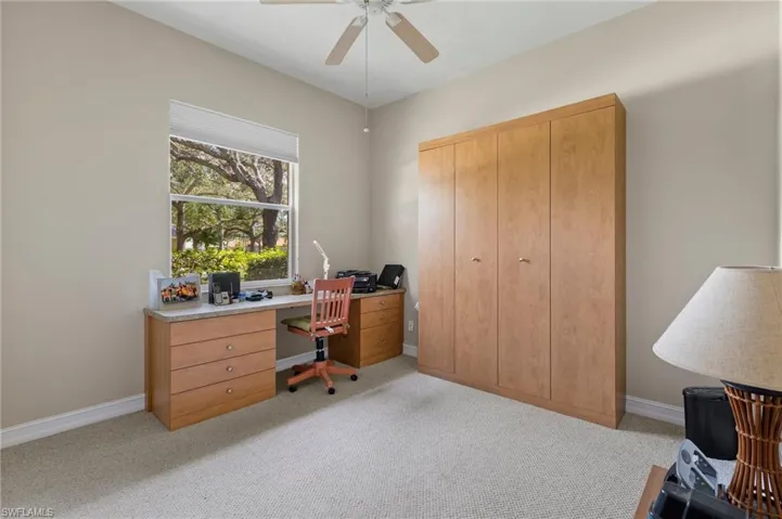 Second bedroom with murphy bed, desk and closet.