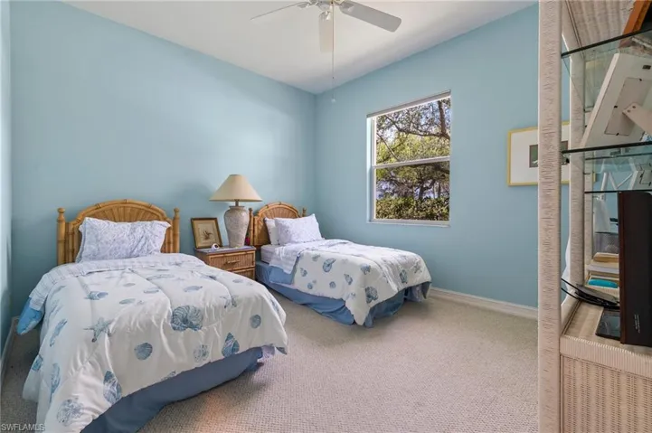 Den used as a third bedroom with twin beds.