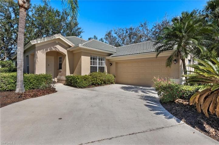 Front of home and driveway with 2 car garage and windows looking out fron the kitchen.