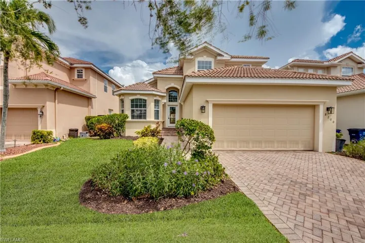 Mediterranean / spanish home featuring a garage and a front yard