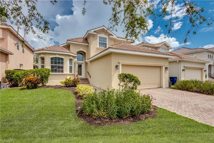 Mediterranean / spanish-style house with a front yard