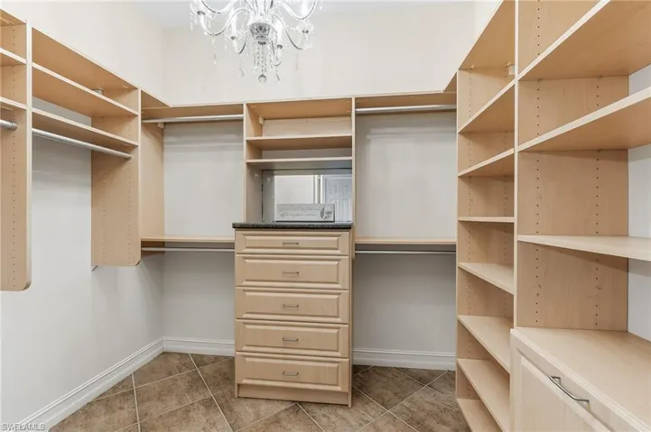 1 of 2 Primary Walk-In Closets w/ Custom Built-Ins