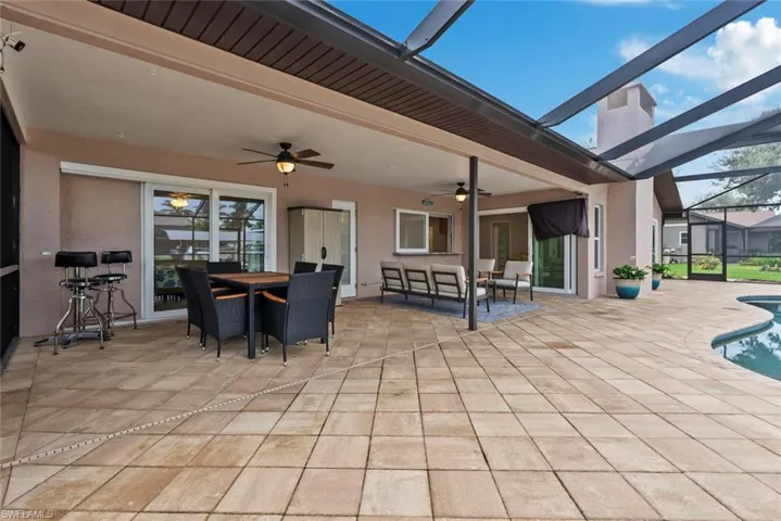 View of patio / terrace featuring glass enclosure and ceiling fan