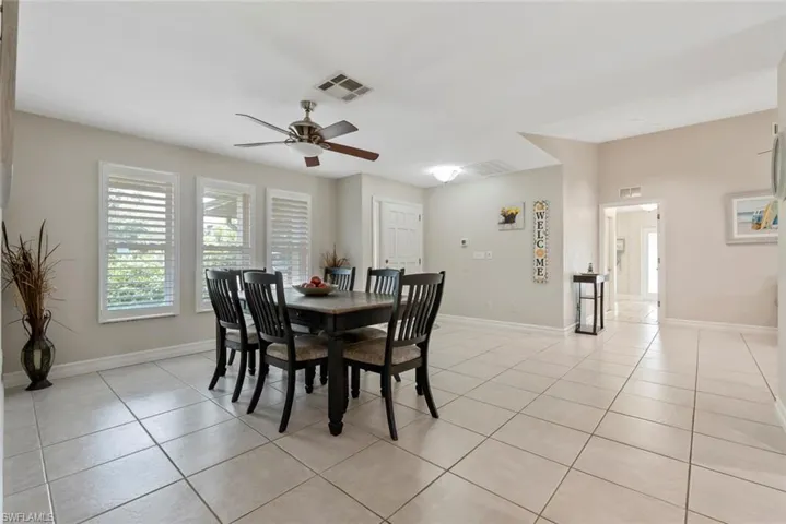 Tiled dining space featuring ceiling fan