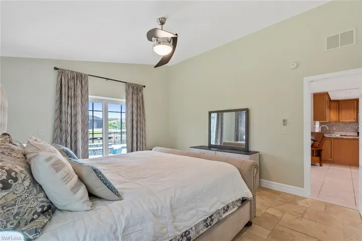 Bedroom featuring vaulted ceiling, sink, and ceiling fan