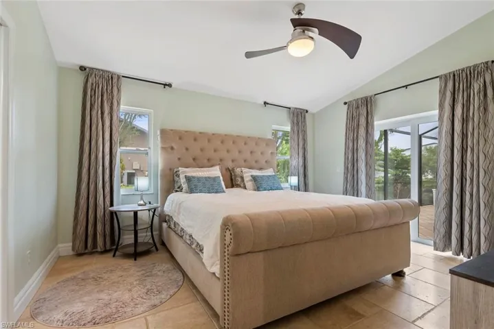Bedroom with lofted ceiling and ceiling fan