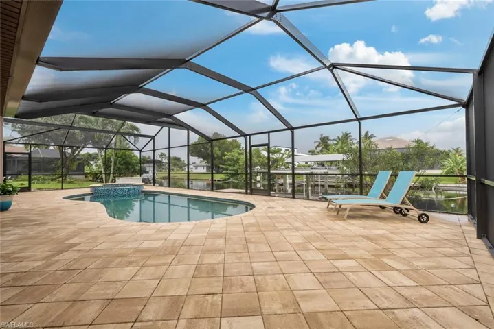 View of swimming pool with a lanai and a patio
