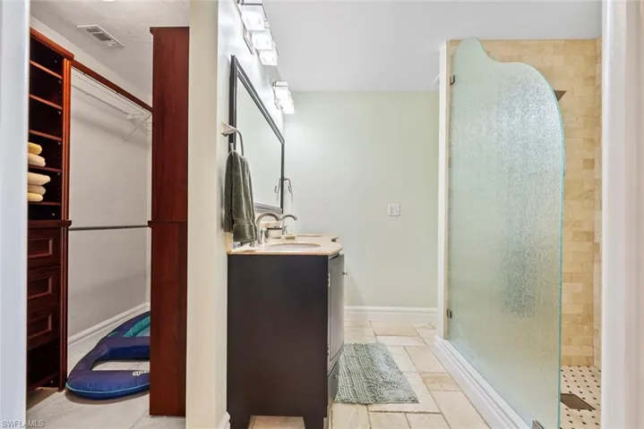 Bathroom featuring vanity and an enclosed shower