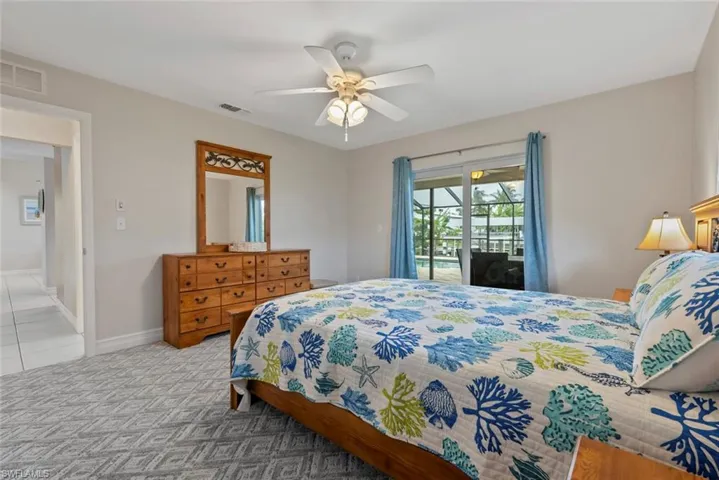 Bedroom featuring ceiling fan and access to exterior