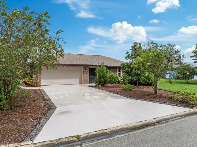 Ranch-style home with a front lawn and a garage