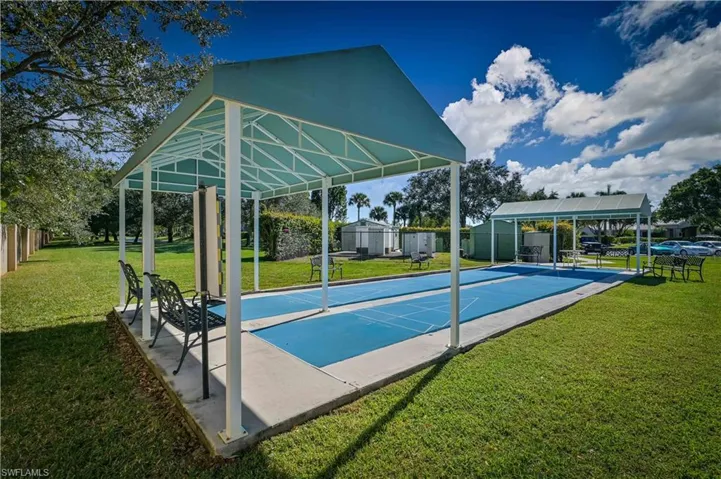 View of community featuring shuffleboard and a patio