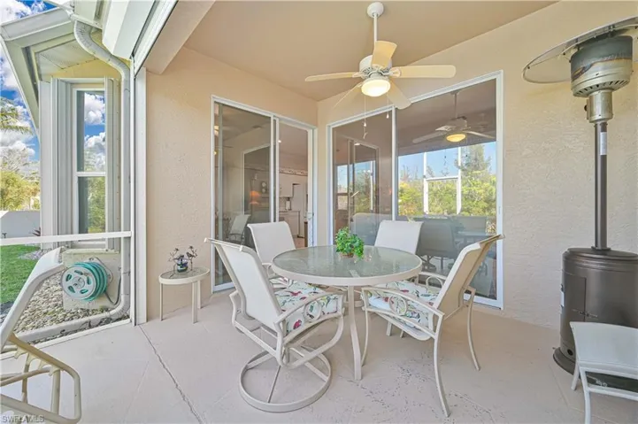 Sunroom / solarium with a patio, outdoor dining space, and a ceiling fan
