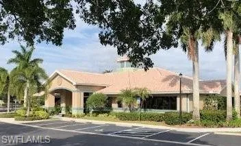 View of building exterior with uncovered parking