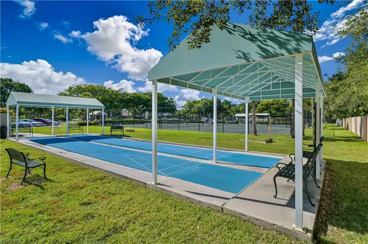 View of property's community featuring shuffleboard