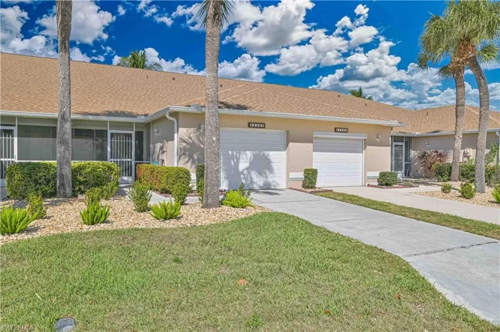 Single story home with concrete driveway, stucco siding, an attached garage, and a sunroom