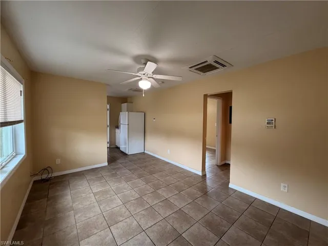 Spare room with a ceiling fan and light tile patterned floors