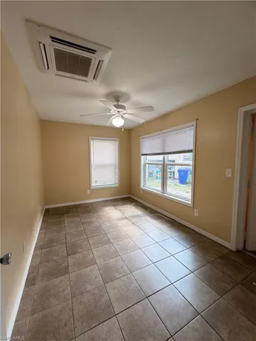 Unfurnished room featuring a ceiling fan and light tile patterned floors